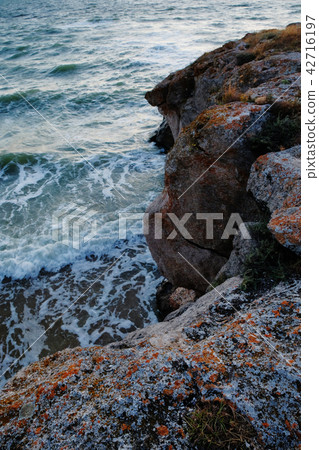 Sea landscape. Evening on the stone beach. Copyspace on water. Sea landscape. Evening on the stone beach. Copyspace on water. 42716197
