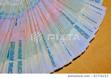 Many thousand notes. Russian rubles. Fan of money on craft paper Many thousand notes. Russian rubles. Fan of money on craft paper 42716223