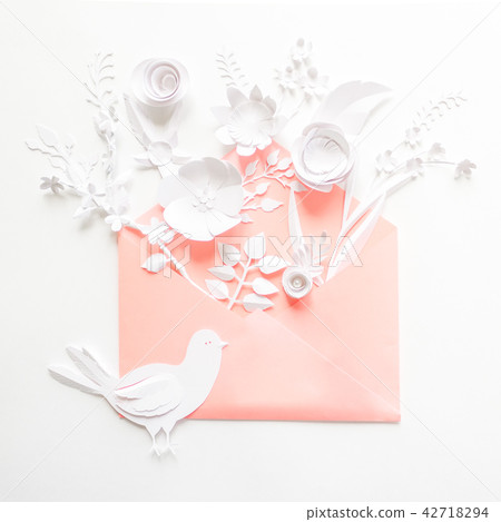 opened pink envelope full of varios paper flowers 42718294