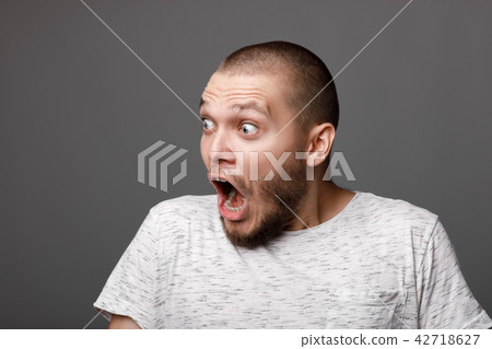 portrait of surprised young man 42718627