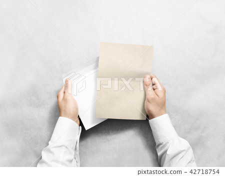 Hand holding envelope and kraft letter mockup 42718754