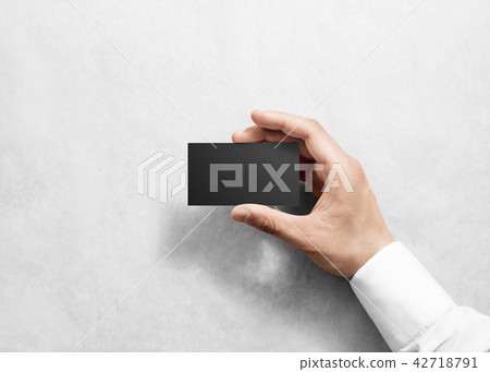 Hand hold blank plain black business card mockup. 42718791