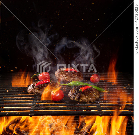 Beef steaks on the grill with flames 42720829