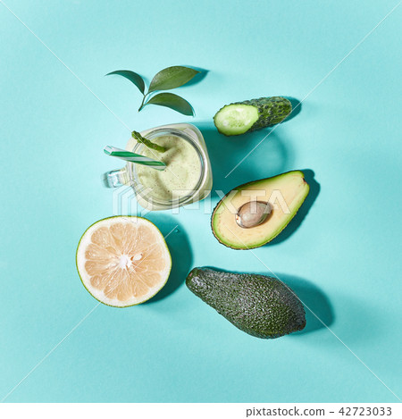 Green detox smoothies from avocado, selery, cucumber in a glass jar on a green paper background Green detox smoothies from avocado, selery, cucumber in a glass jar on a green paper background 42723033