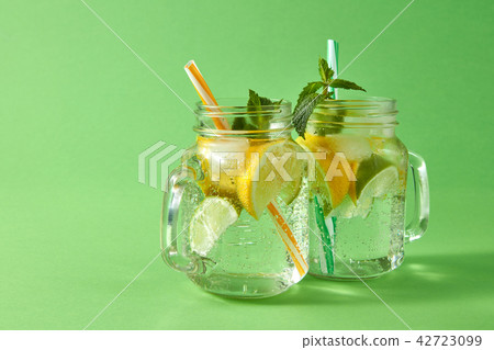 Cold natural lemonade with bubbles of air from natural tropical ingredients - citrus fruits slices 42723099