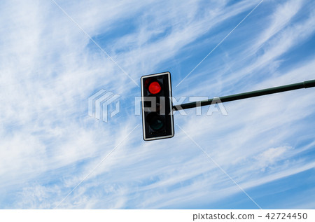 Traffic lights against cloudy blue sky 42724450