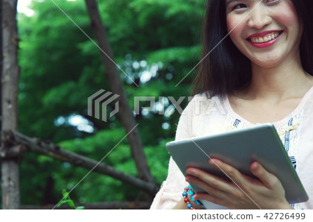 Beautiful girl happy playing tablet device working Beautiful girl happy playing tablet device working 42726499