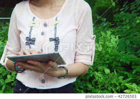 Beautiful girl happy playing tablet device working Beautiful girl happy playing tablet device working 42726501
