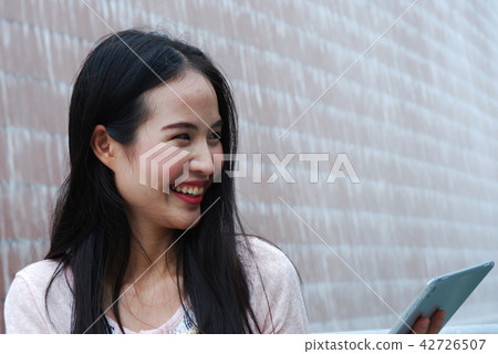 Beautiful girl happy playing tablet device working 42726507