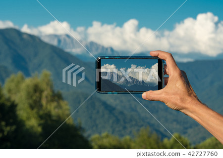 Hand making photo with smartphone camera closeup, view tourist hands using gadget phone in travel on Hand making photo with smartphone camera closeup, view tourist hands using gadget phone in travel on 42727760
