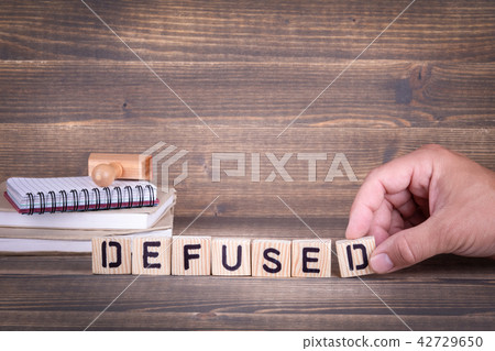 defused. wooden letters on the office desk 42729650