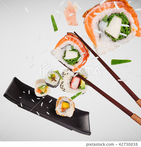 Pieces of delicious japanese sushi frozen in the air. 42730838