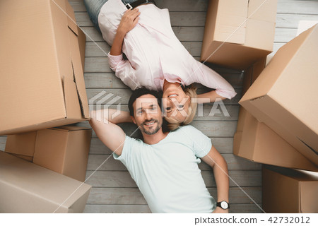 Top view. Adult Happy Family Lying Side by Side. Top view. Adult Happy Family Lying Side by Side. 42732012