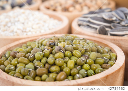 Cereal grains , seeds, beans on wooden background Cereal grains , seeds, beans on wooden background 42734662