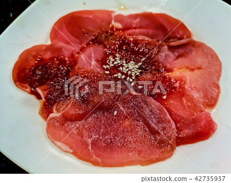 Sliced raw pork on white dish Sliced raw pork on white dish 42735937