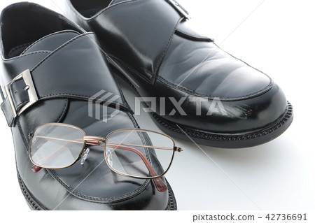 Leather shoes and reading glasses Leather shoes and reading glasses 42736691