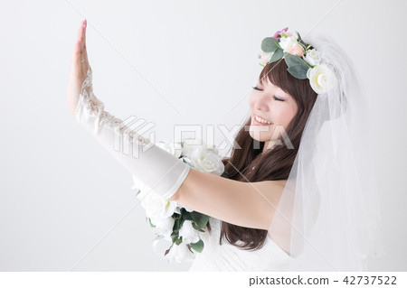 A smiling bride watching the ring 42737522