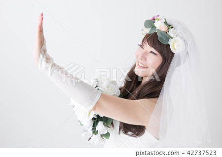 A smiling bride watching the ring A smiling bride watching the ring 42737523