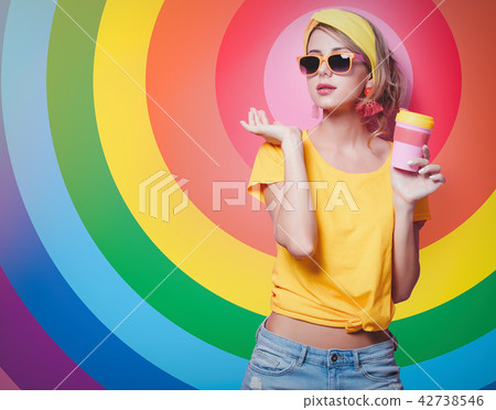 Girl holding a red cup of coffee Girl holding a red cup of coffee 42738546