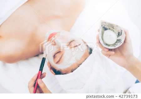Beautiful woman having a facial treatment at spa. Beautiful woman having a facial treatment at spa. 42739173