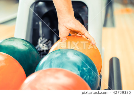 Young man playing bowling. Young man playing bowling. 42739380