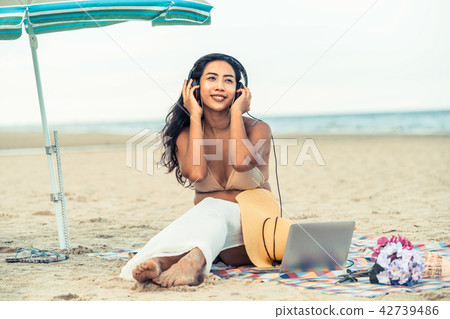 Plus size young woman sitting on the beach. Plus size young woman sitting on the beach. 42739486