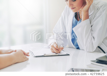 Woman Doctor and Female Patient in Hospital Office 42739625