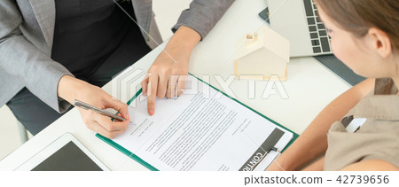 Client Signs Document to Buy House and Real Estate 42739656
