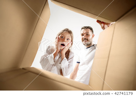 dad with daughter unpacking and opening carton box and looking inside dad with daughter unpacking and opening carton box and looking inside 42741179