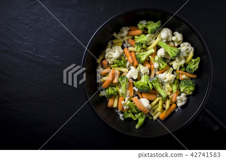 Frozen vegetables in black frying pan Frozen vegetables in black frying pan 42741583