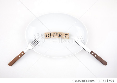 Diet letters and knife with fork over white plate 42741795