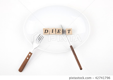 Diet letters and knife with fork over white plate Diet letters and knife with fork over white plate 42741796