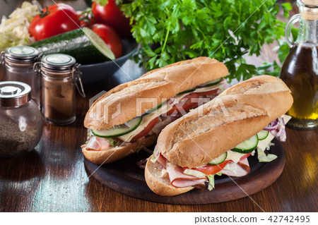 Submarine sandwiches with ham and cheese 42742495
