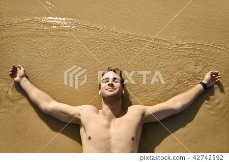 Tanned guy on beach Tanned guy on beach 42742592
