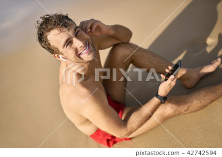 Tanned guy on beach 42742594