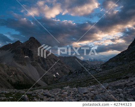 The Alps at sunrise. Colorful sky majestic peaks The Alps at sunrise. Colorful sky majestic peaks 42744323