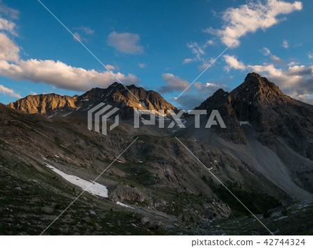 The Alps at sunrise. Colorful sky majestic peaks The Alps at sunrise. Colorful sky majestic peaks 42744324