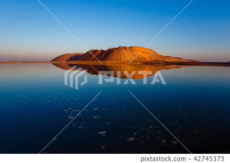 Huge potassuim waste mountain at sunset Huge potassuim waste mountain at sunset 42745373