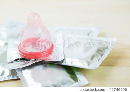 Close up shot of various condom pack on wooden Close up shot of various condom pack on wooden 42746996