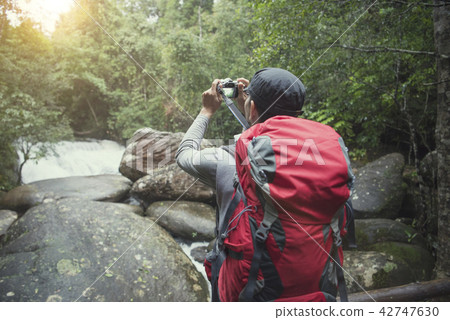 traveler photographing with backpack and enjoying  42747630