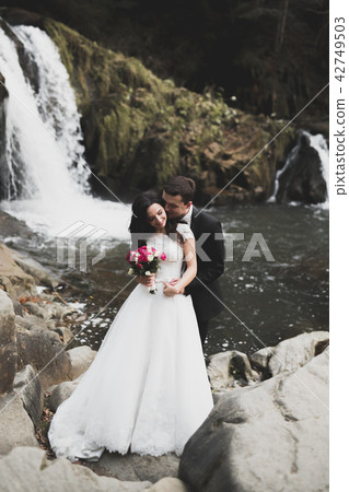 Wedding couple, groom and bride hugging, outdoor near river Wedding couple, groom and bride hugging, outdoor near river 42749503