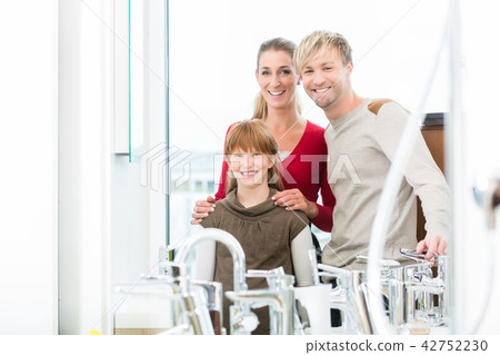 Portrait of a happy family together in the interior of a modern shop 42752230
