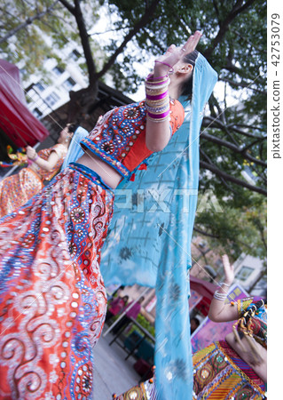 Girls in colorful bright costumes dance. Girls in colorful bright costumes dance. 42753079