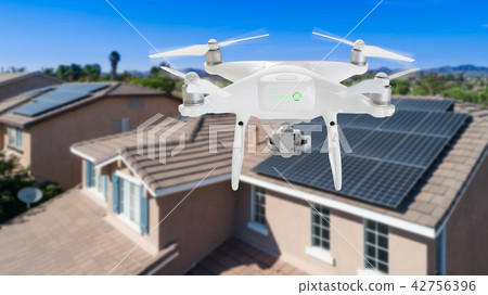 UAV Drone Inspecting Solar Panels On Large House UAV Drone Inspecting Solar Panels On Large House 42756396
