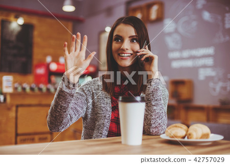 Young Woman with Mobile in Cafe. 42757029