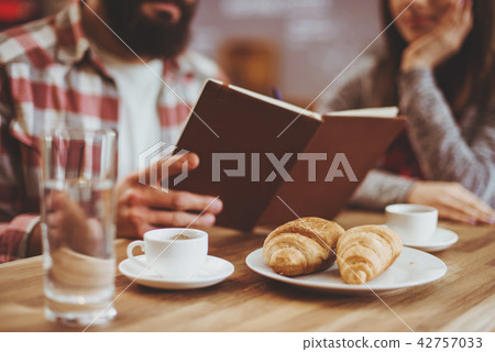 Couple Reading in Cafe. Couple Reading in Cafe. 42757033