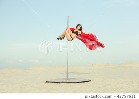 Woman is spinning on the pole. Woman is spinning on the pole. 42757611