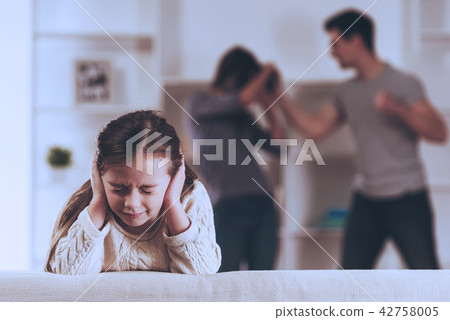 Sad Girl and Quarreling in Kitchen. 42758005