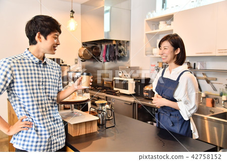 男性客人從咖啡館的女店員那裡收到咖啡 男性客人從咖啡館的女店員那裡收到咖啡 42758152