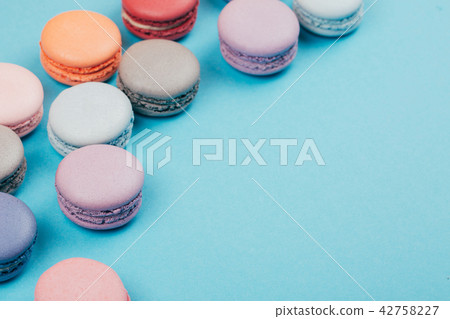 Group of pastel colorful macarons on trendy background 42758227